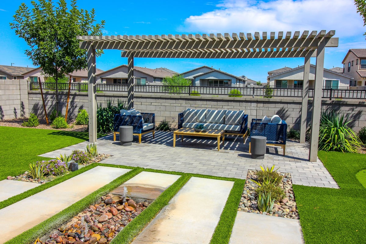 Rear yard lattice pergola with wicker patio furniture